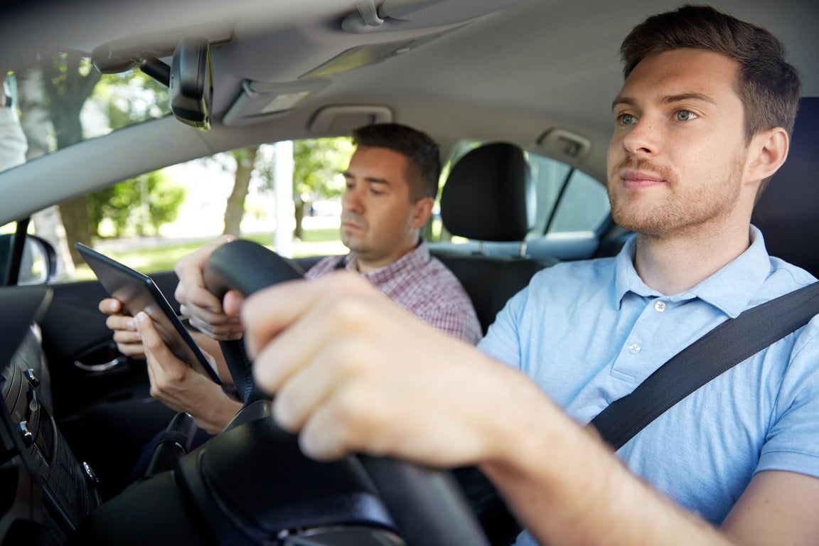 Car Driving School Instructor with Male Student Driver